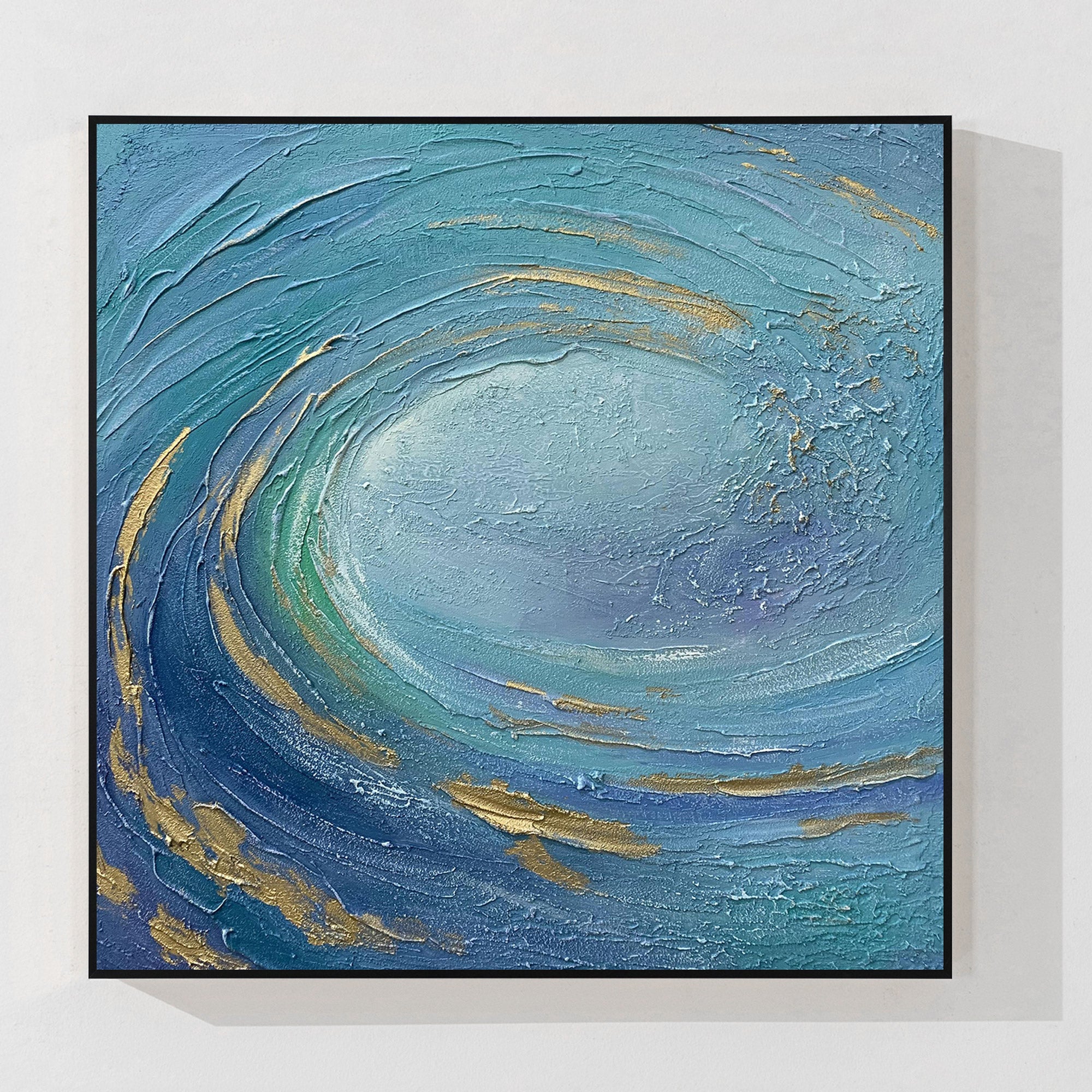 Abstract 3D textured ocean wave canvas wall art featuring swirling teal and navy blue impasto texture with metallic gold accents in a black frame.
