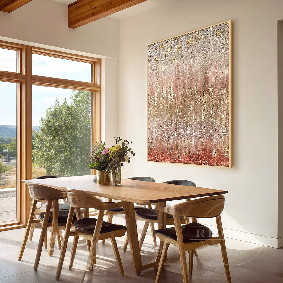 Rose gold glitter abstract artwork hanging in an elegant contemporary dining area.