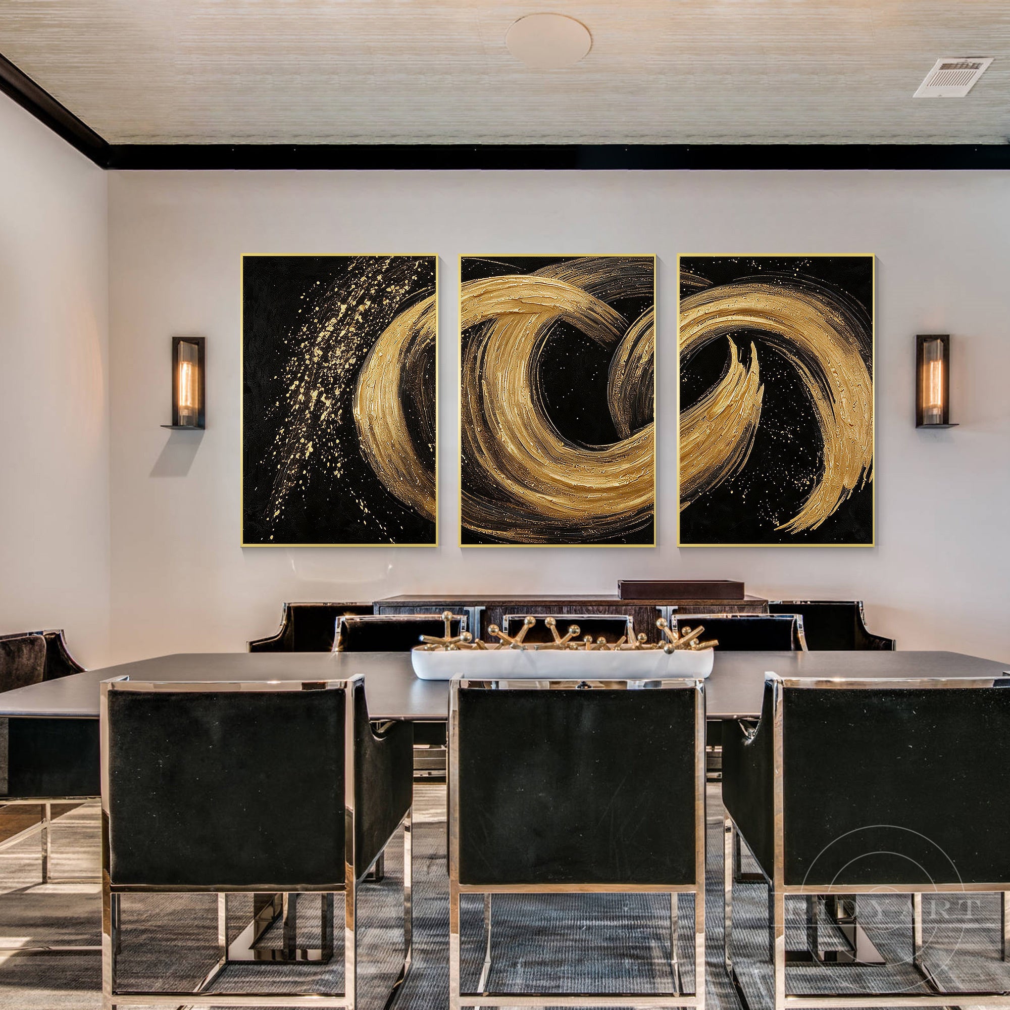 Luxury 3-piece gold foil on deep black background abstract art set hanging in a sleek modern dining room with velvet chairs and wall sconces.
