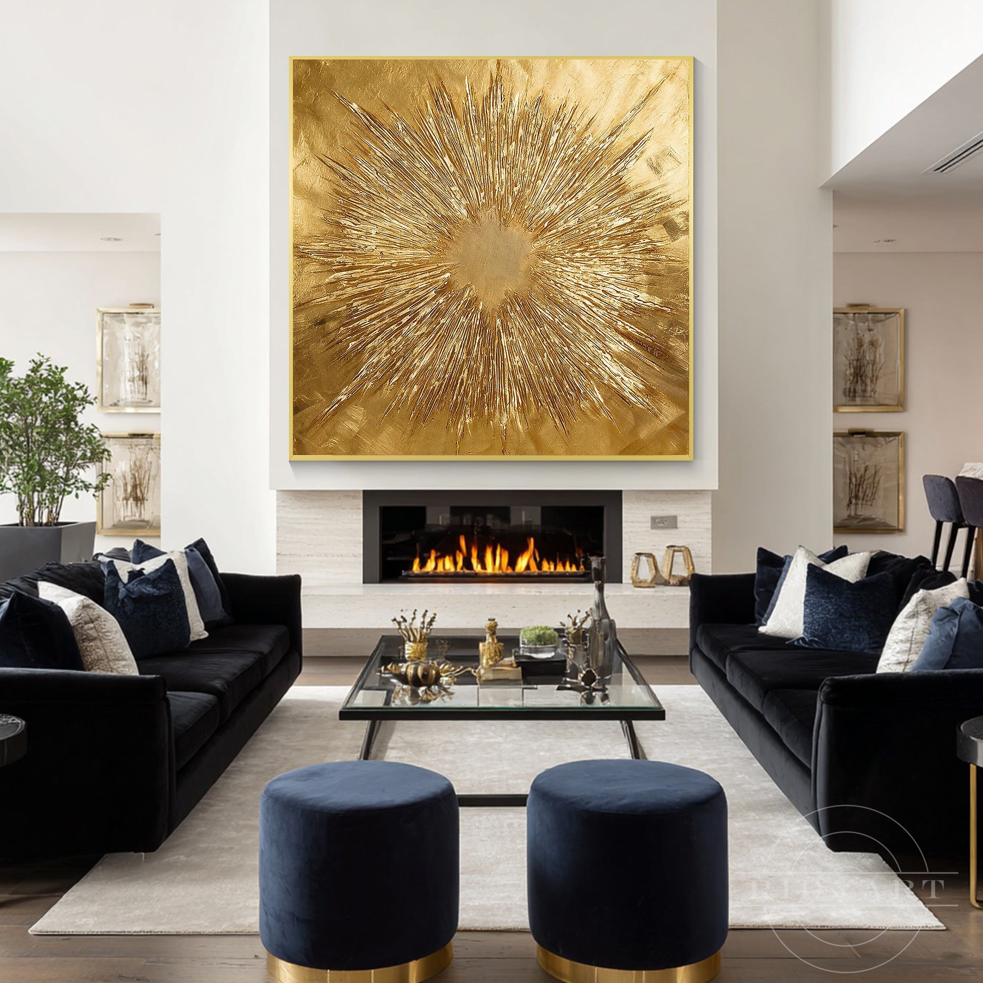 Large square gold abstract wall art framed in gold hanging in a high-ceiling modern living room with cognac leather armchairs and grey sofas.