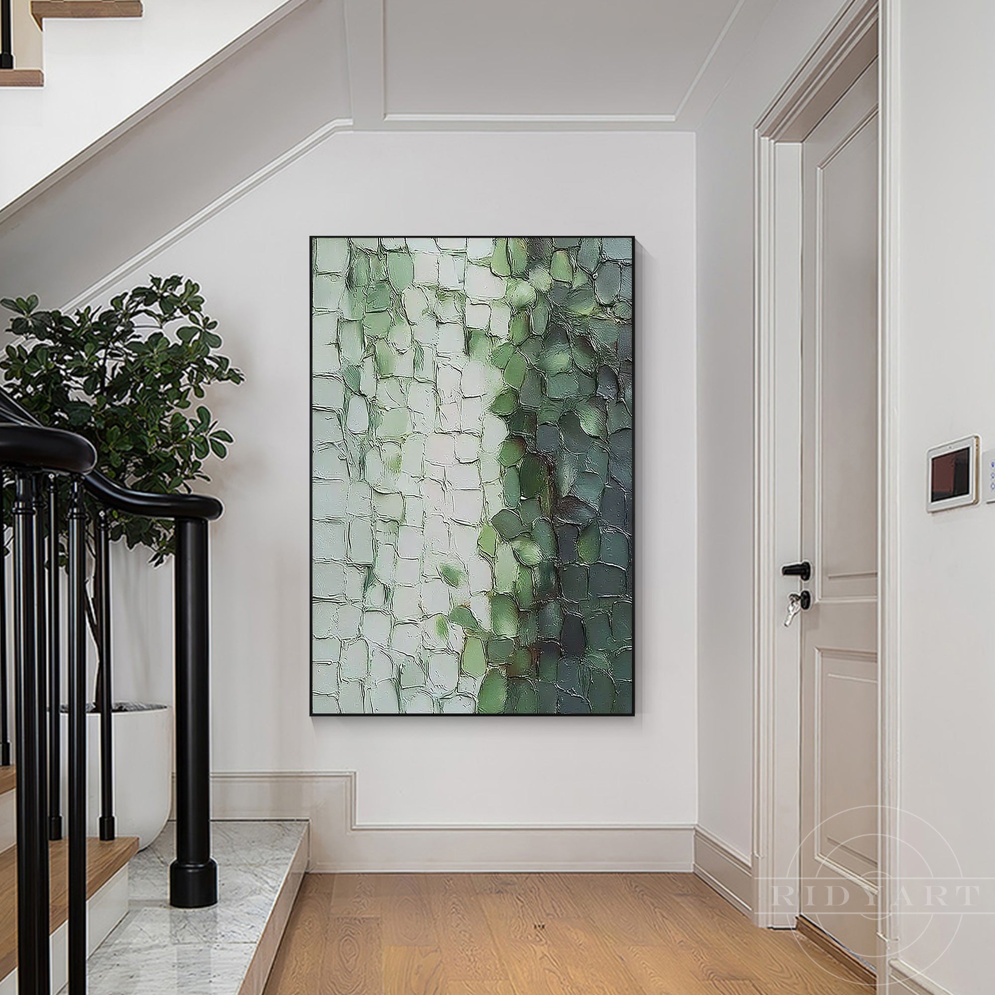Oversized vertical abstract painting in green and white tones hanging in a high-end white hallway next to a staircase.
