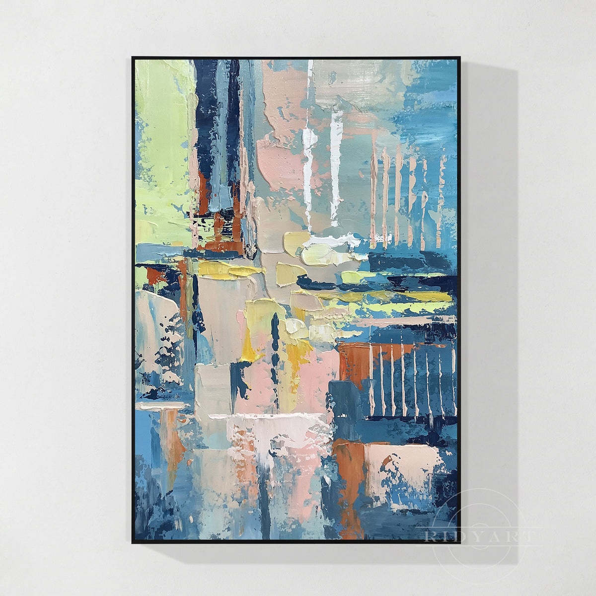 Abstract oil painting canvas wall art with blue, blush pink, and yellow texture in a thin white frame.