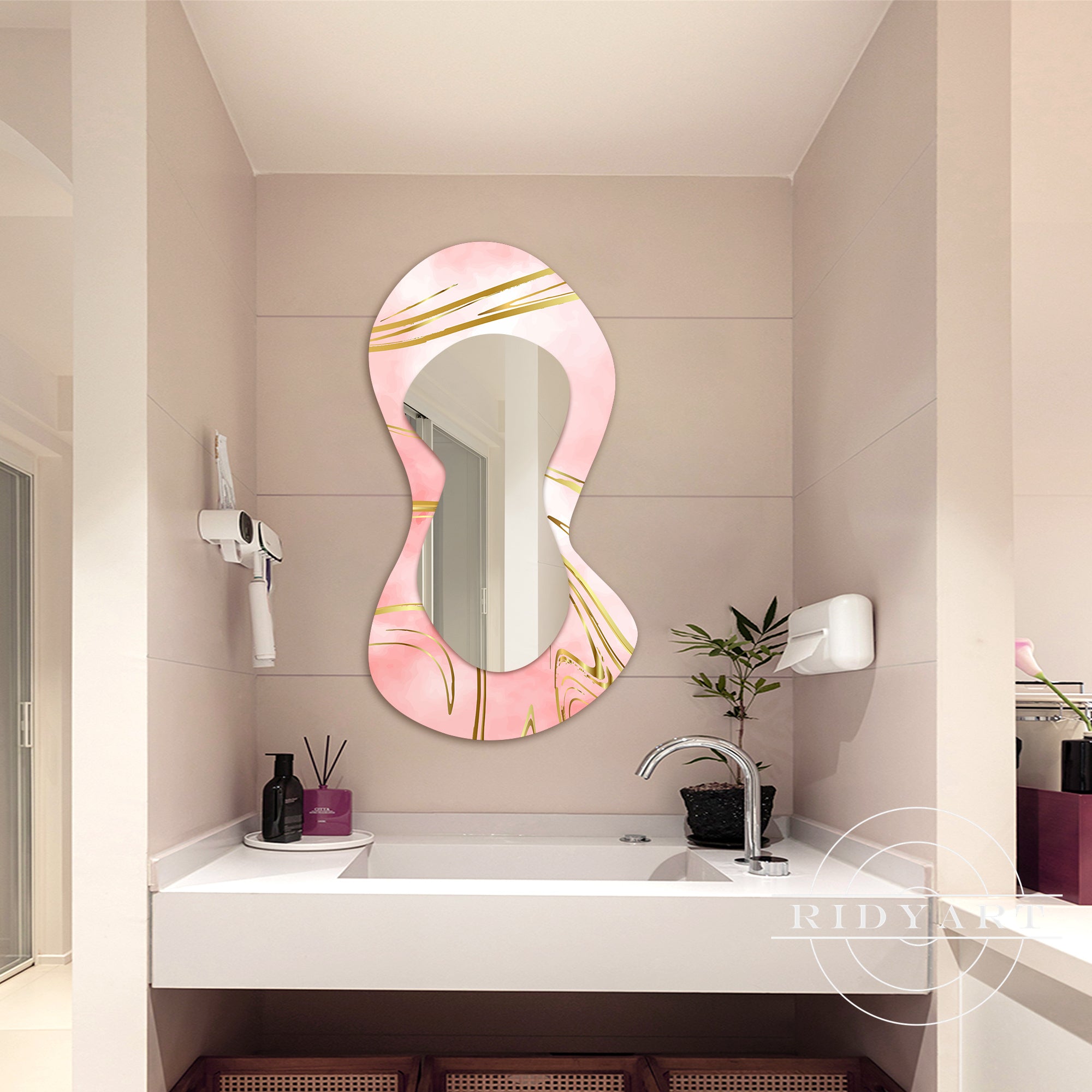 Pink and gold spray-painted shaped mirror for vanity