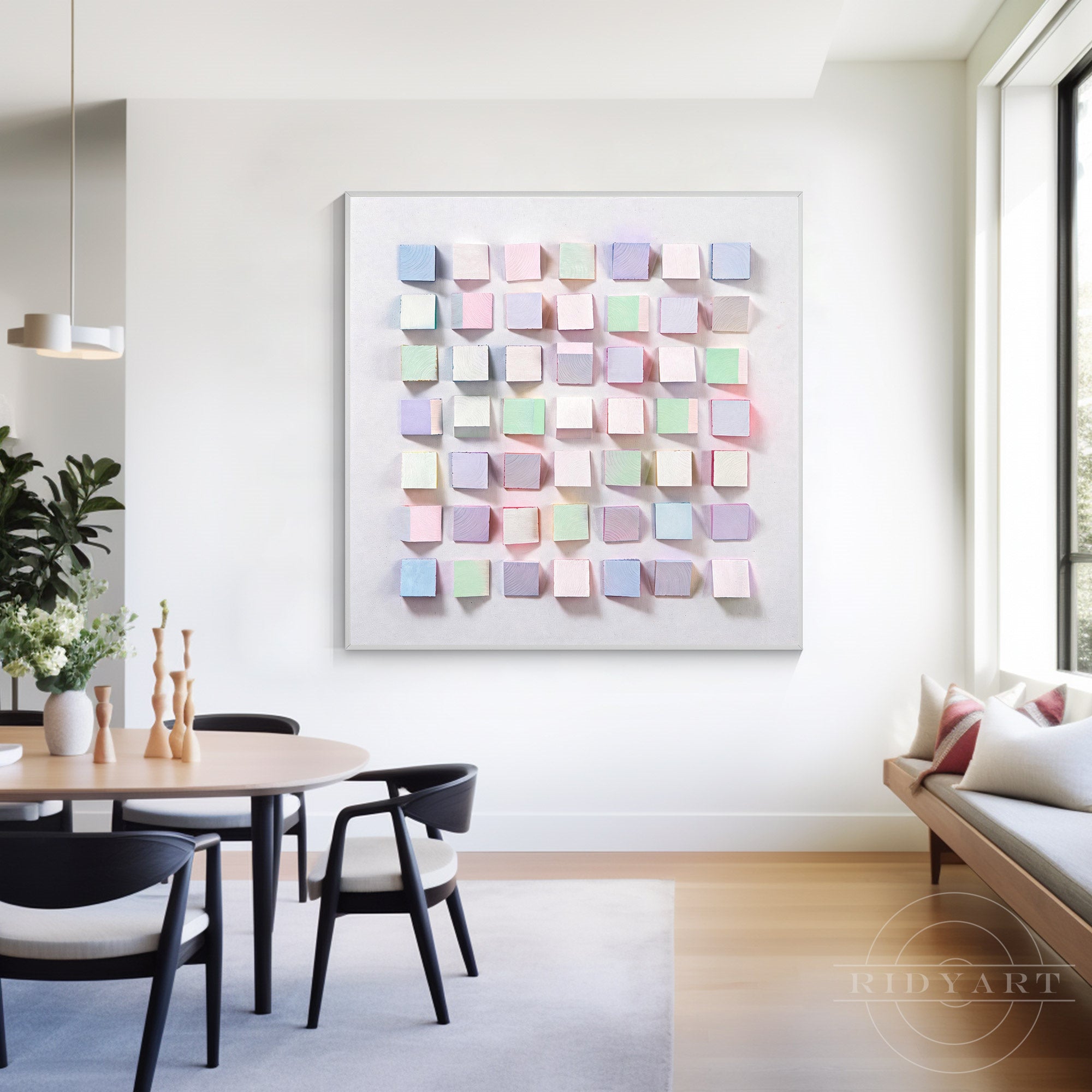 Soft pastel 3D geometric wooden block sculpture wall painting displayed in a modern white dining room above a wooden table.