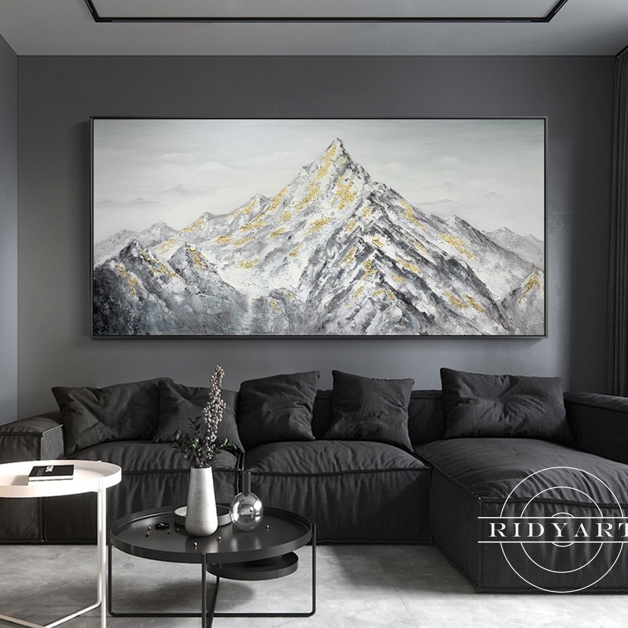Textured mountain scene artwork in white, gray, and gold