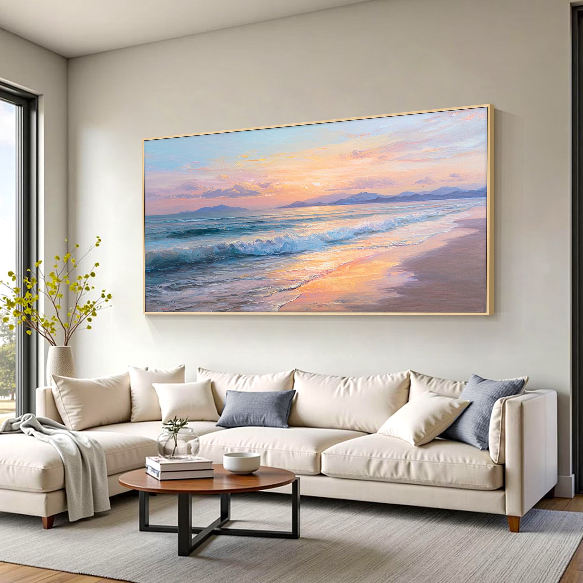 Modern coastal wall art above sectional sofa in open living room