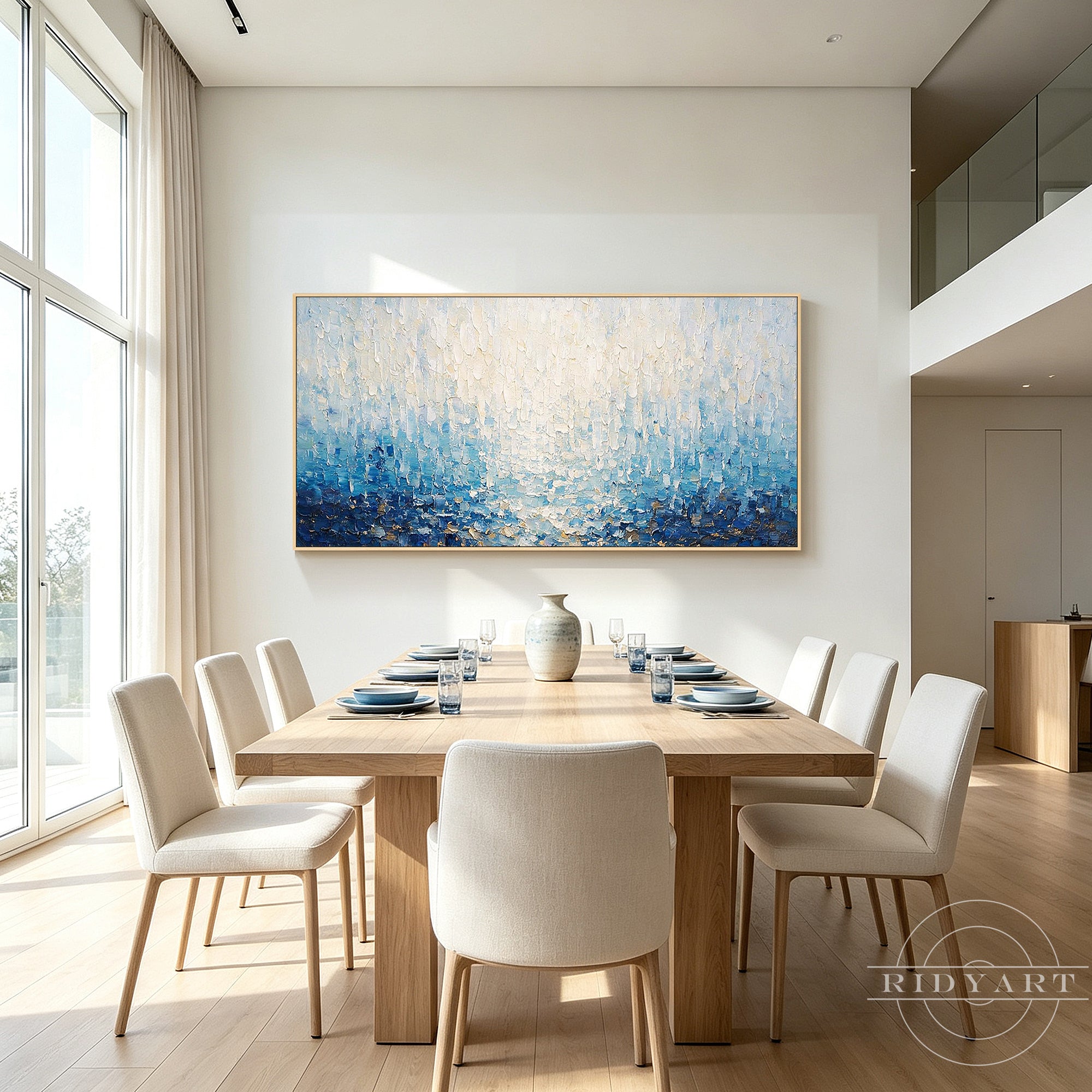 Ocean-inspired blue abstract oil painting with white frame on a neutral wall