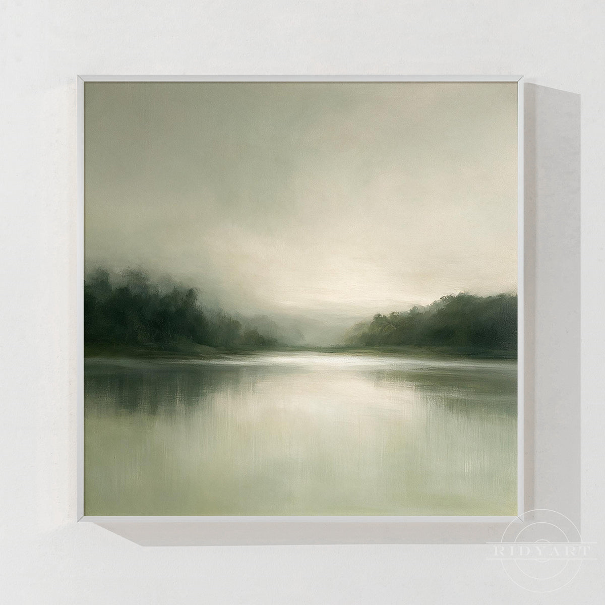 Hand painted misty lake landscape oil painting in soft sage green tones mounted above a modern grey sofa in a minimalist living room interior.