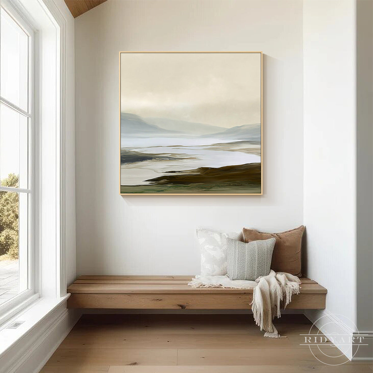 Tranquil hand painted earthy coastal landscape square canvas artwork mounted above a beige upholstered bed frame in a soothing bedroom decor.