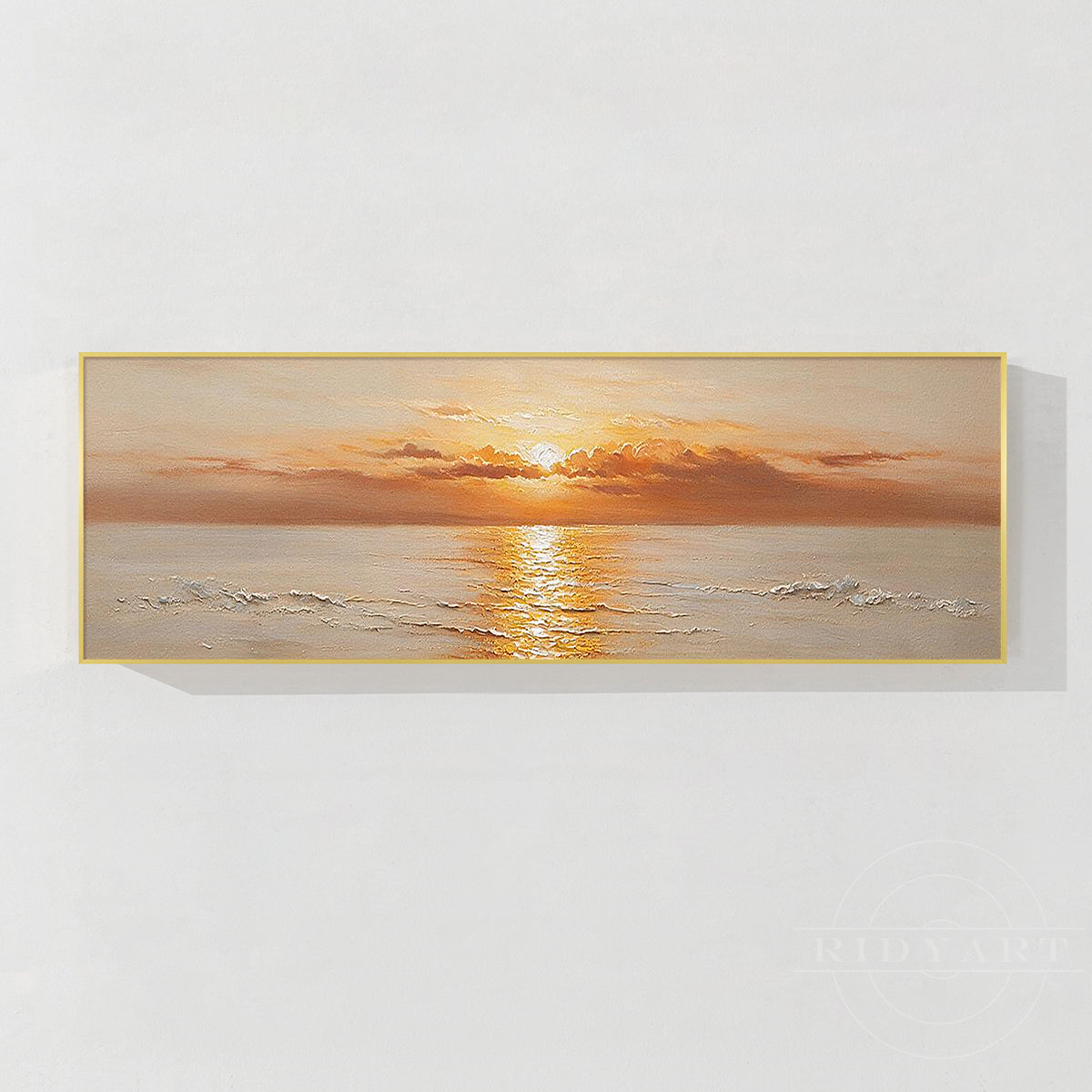 Horizontal abstract oil painting featuring a golden ocean sunset in a slim gold frame on a white wall.