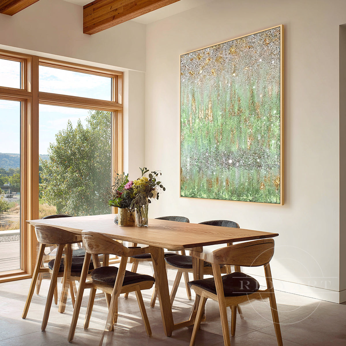 Sage green abstract wall painting with champagne gold sparkle hanging in a light dining room.