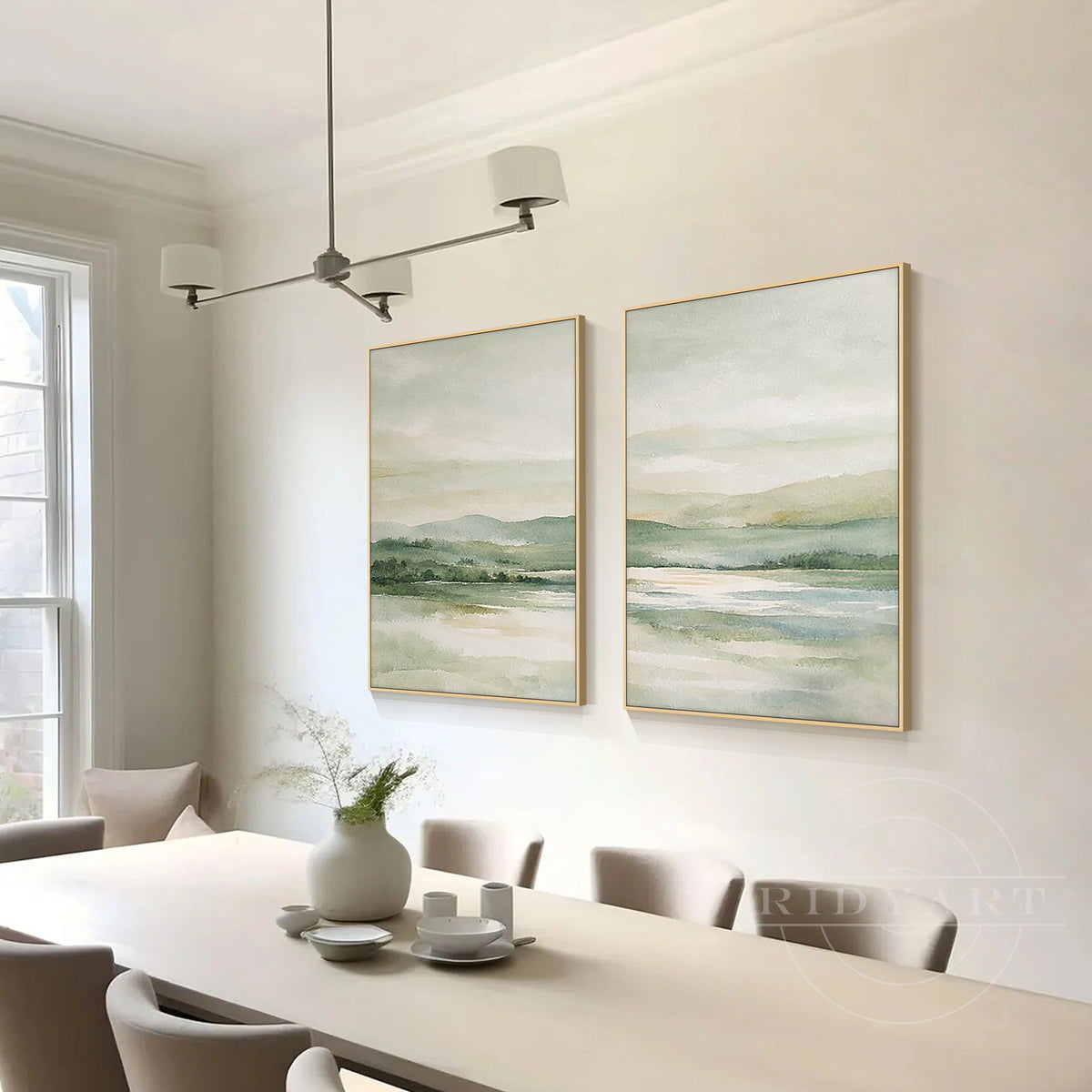 Sage green mountain lake diptych wall art with misty landscape and gold frames styled in a neutral modern living room.