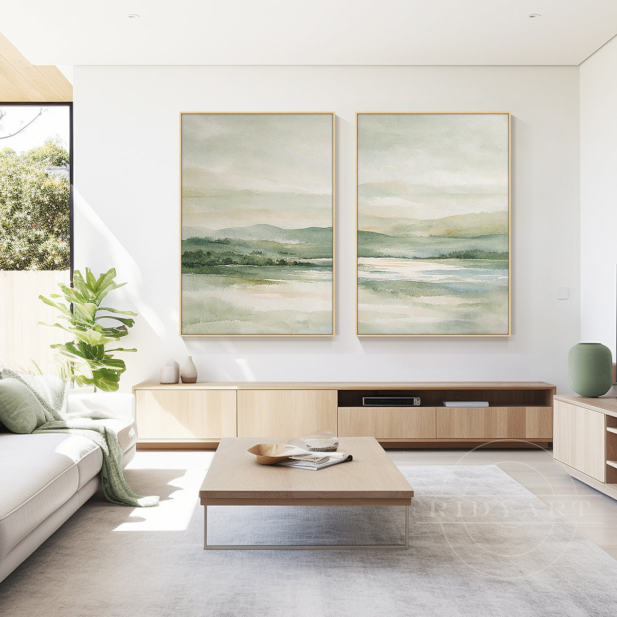 Misty sage green mountain lake wall art with slim gold frames displayed in an elegant neutral dining room.