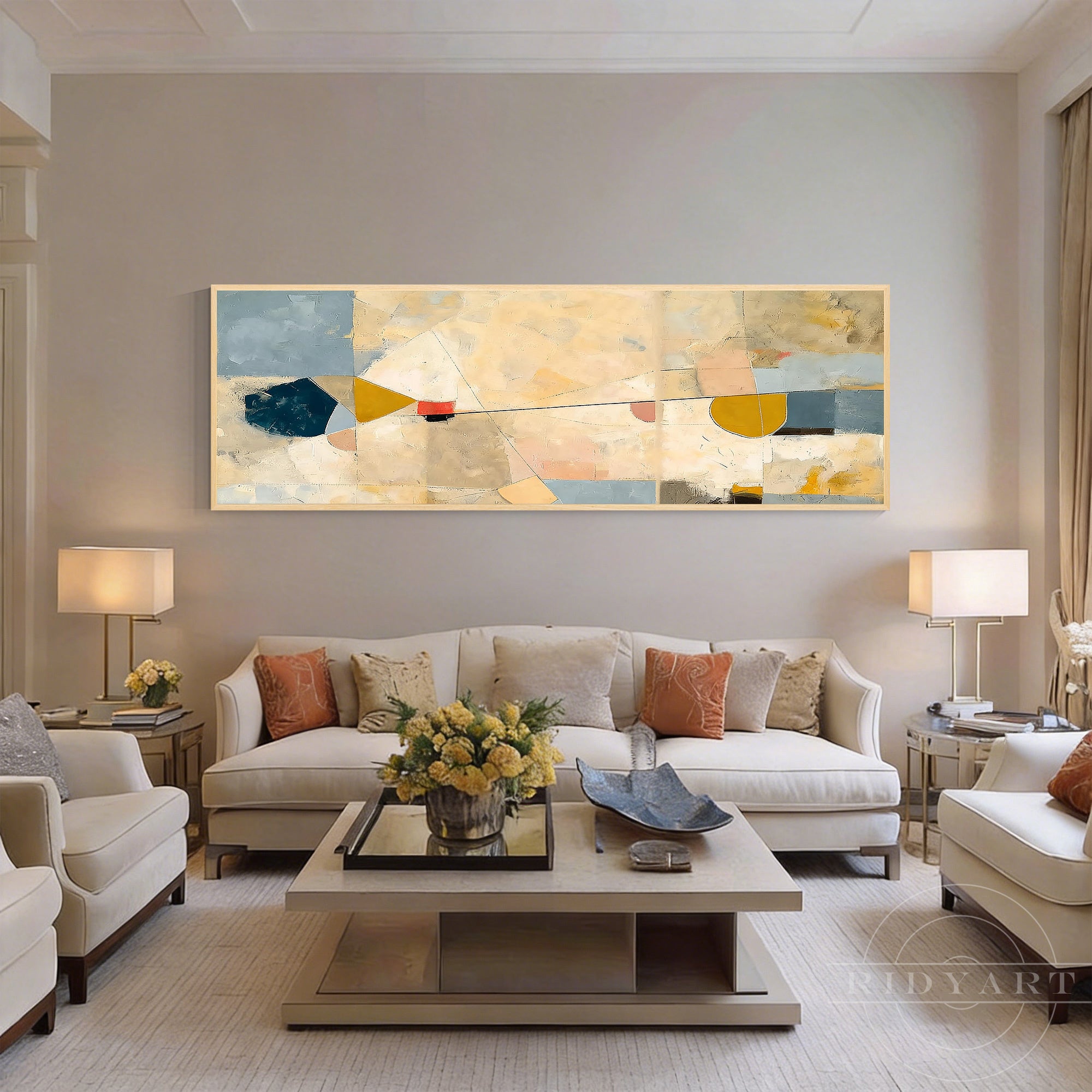 Wide panoramic geometric abstract canvas painting with yellow and blue shapes mounted on a warm beige wall in a luxury living room.
