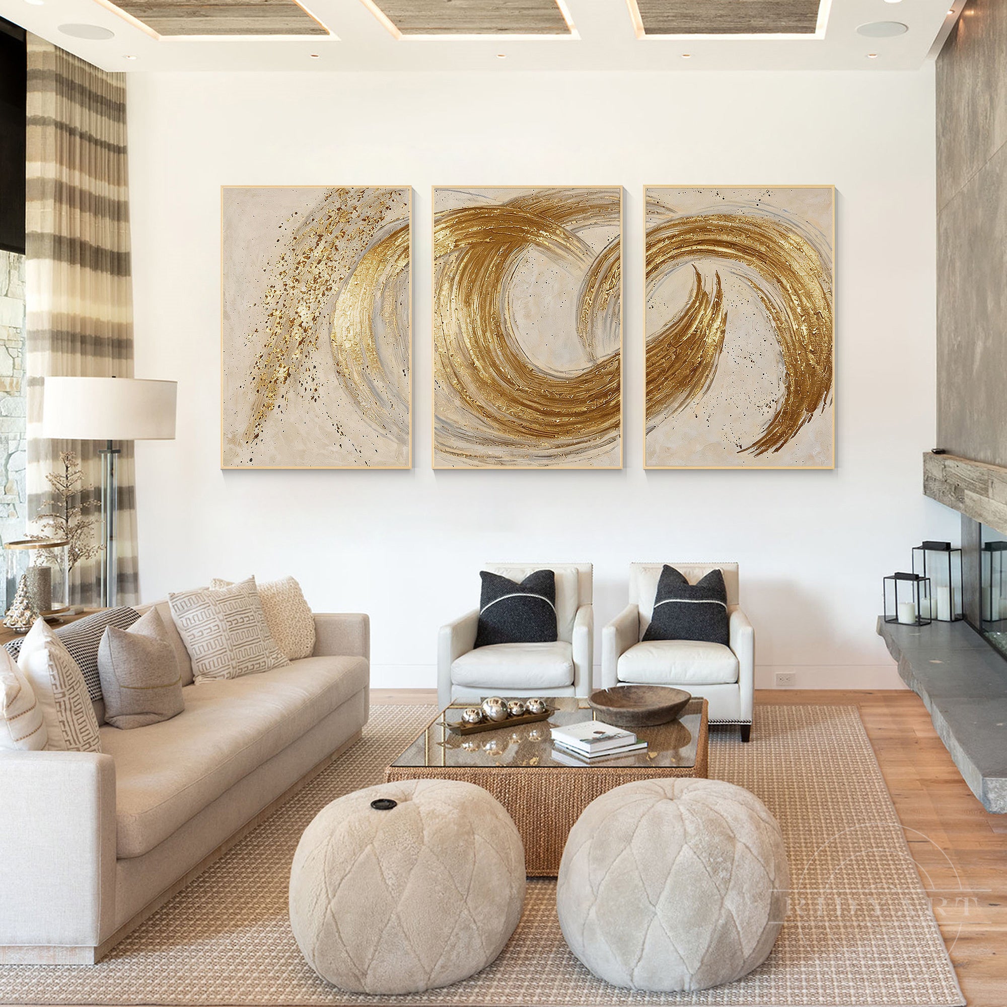 Modern 3-piece gold leaf abstract triptych painting set mounted on a white living room wall above a beige sofa with modern cream armchairs.