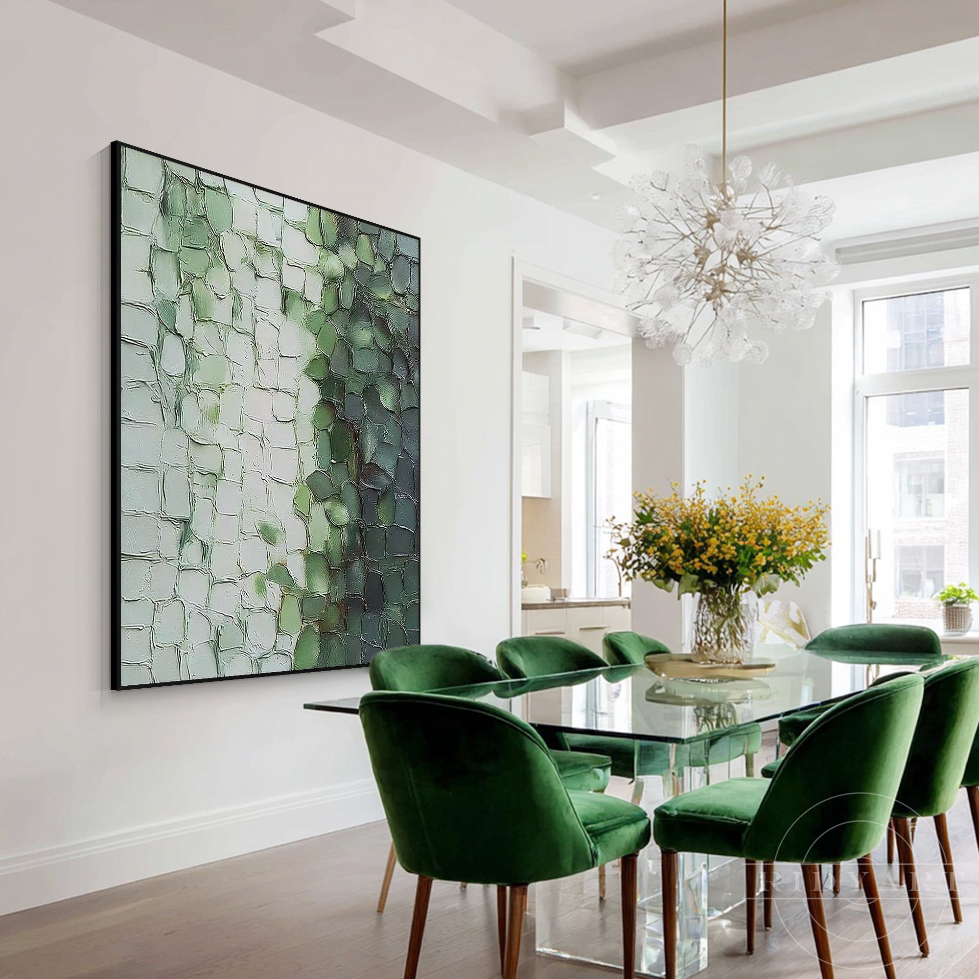 Impasto abstract canvas wall art displayed next to a contemporary glass dining table with dark green velvet chairs.