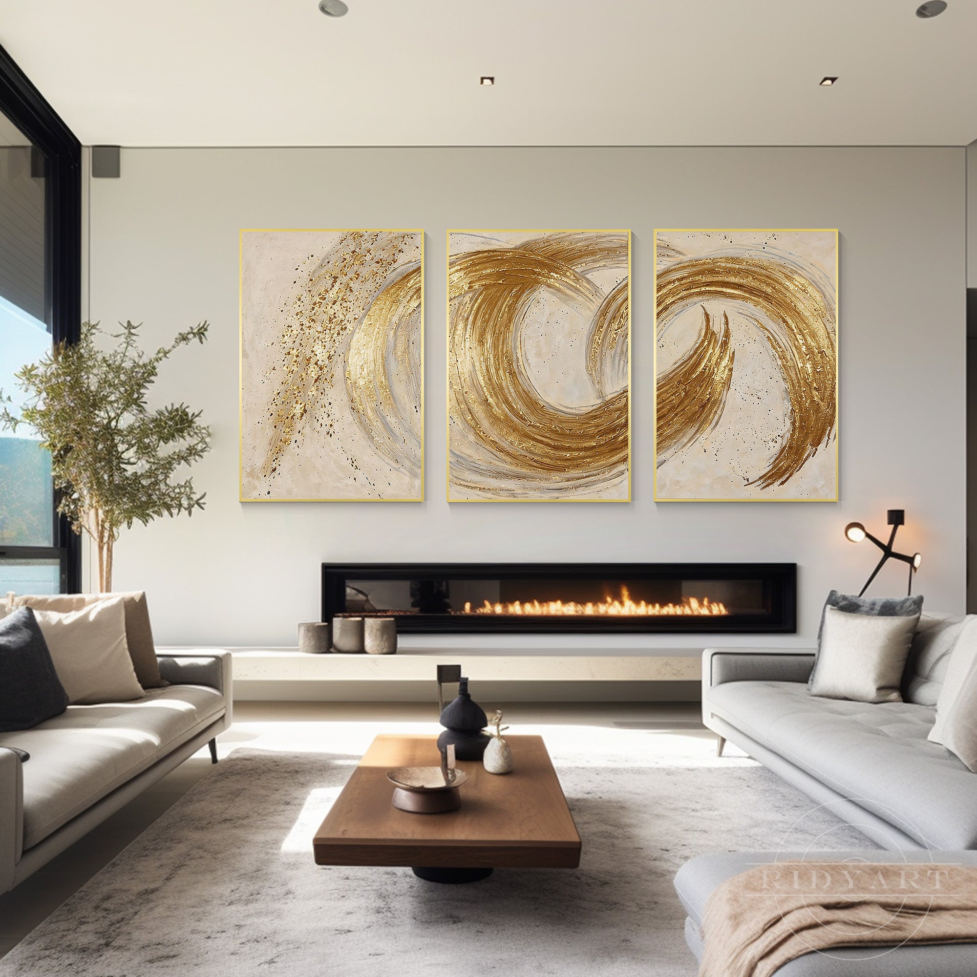 Luxurious 3-piece gold abstract canvas wall art hanging above a modern horizontal fireplace in a bright, spacious minimalist living room.
