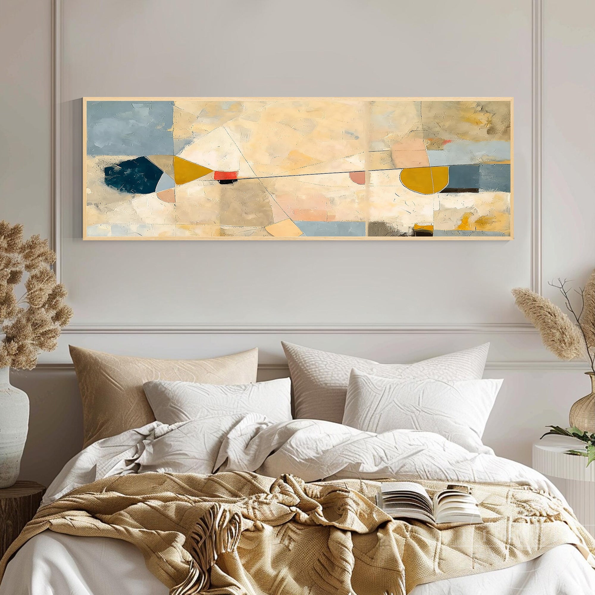 Long horizontal abstract canvas art hanging above a plush upholstered bed in a serene neutral-toned master bedroom.