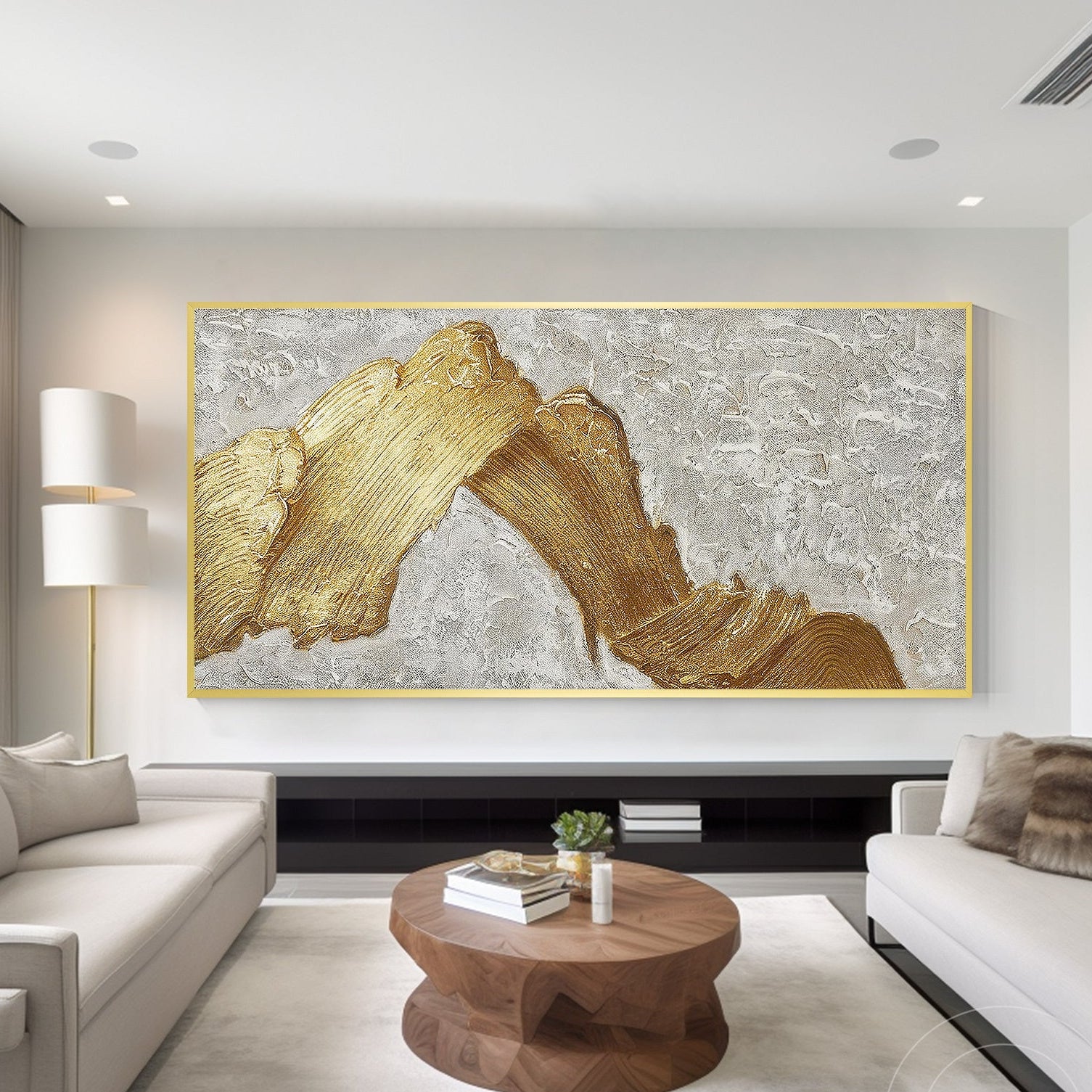 Oversized gold abstract wall art above a low TV stand in a modern minimalist living room.