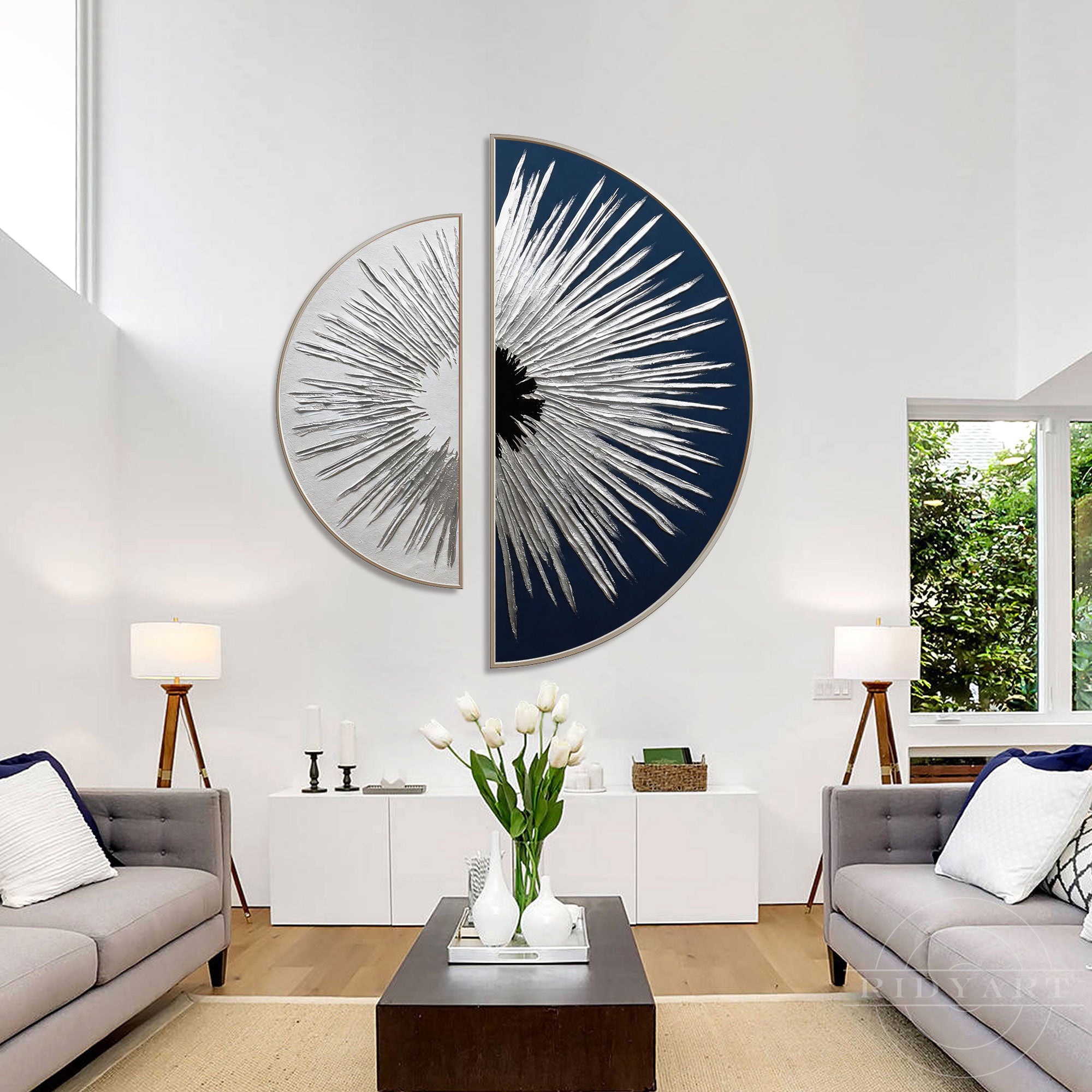 Minimalist bright living room featuring a white credenza table, grey sofas, and a bold navy and silver sunburst half circular wall art.