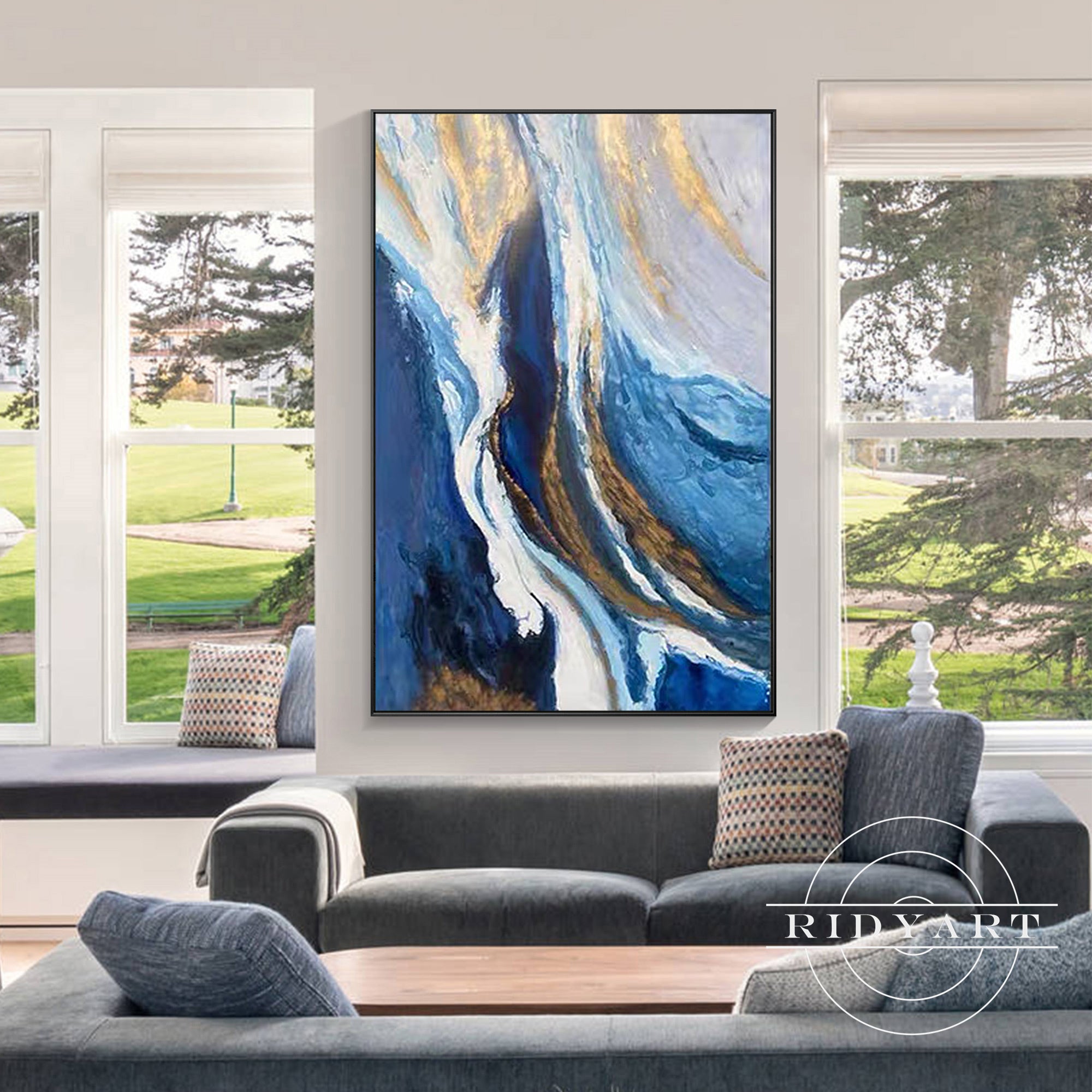 Abstract painting with blue, white, and gold flowing patterns.