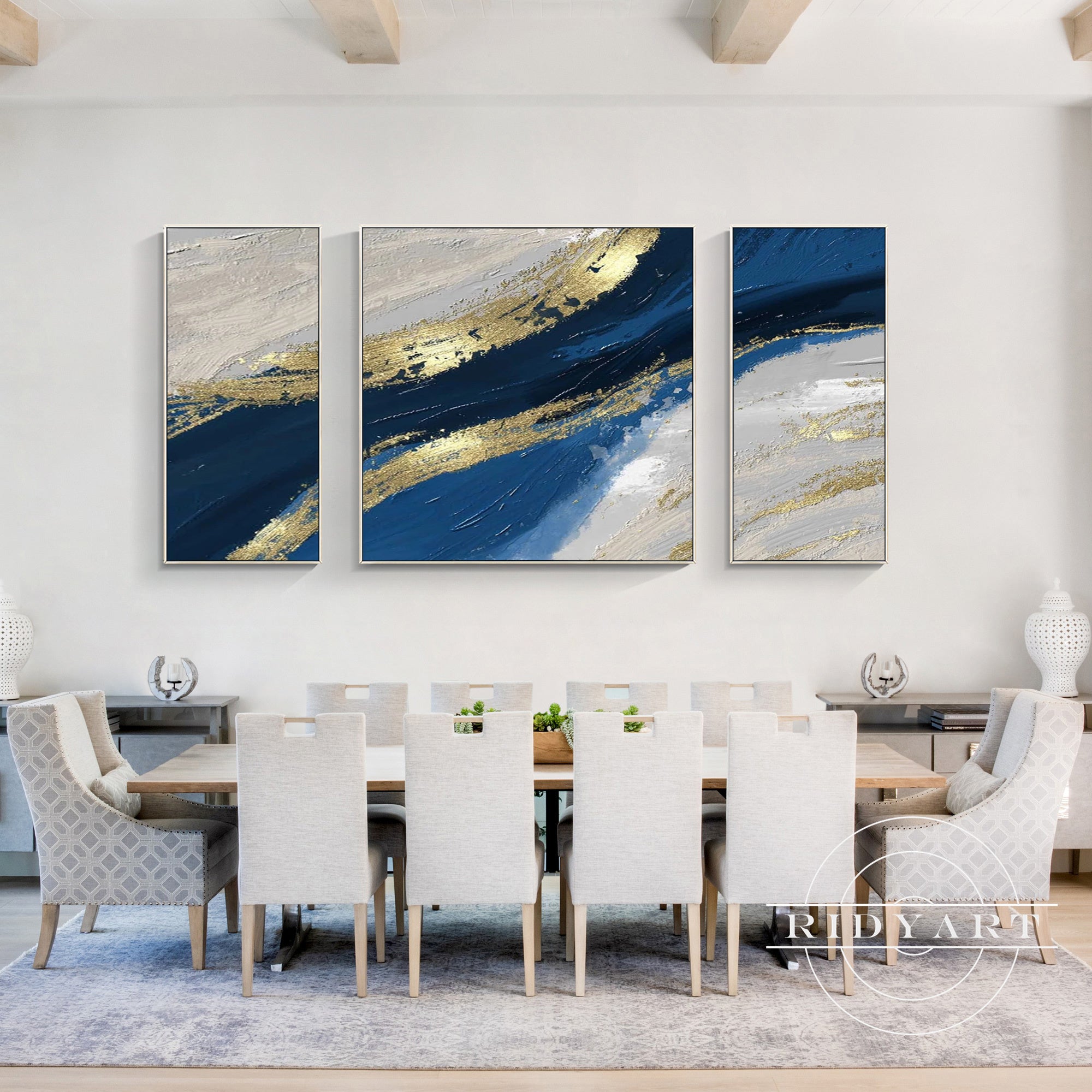 Abstract triptych painting with blue, gold, and white textures.