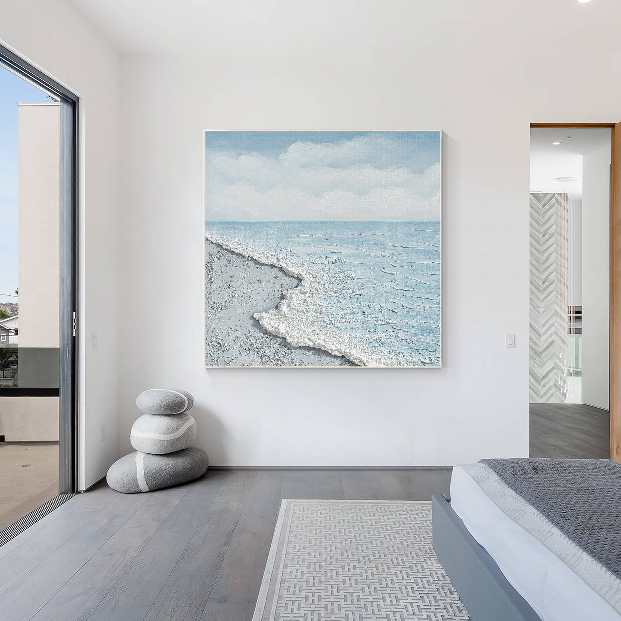 Textured coastal wall art featuring ocean waves in light blue and white