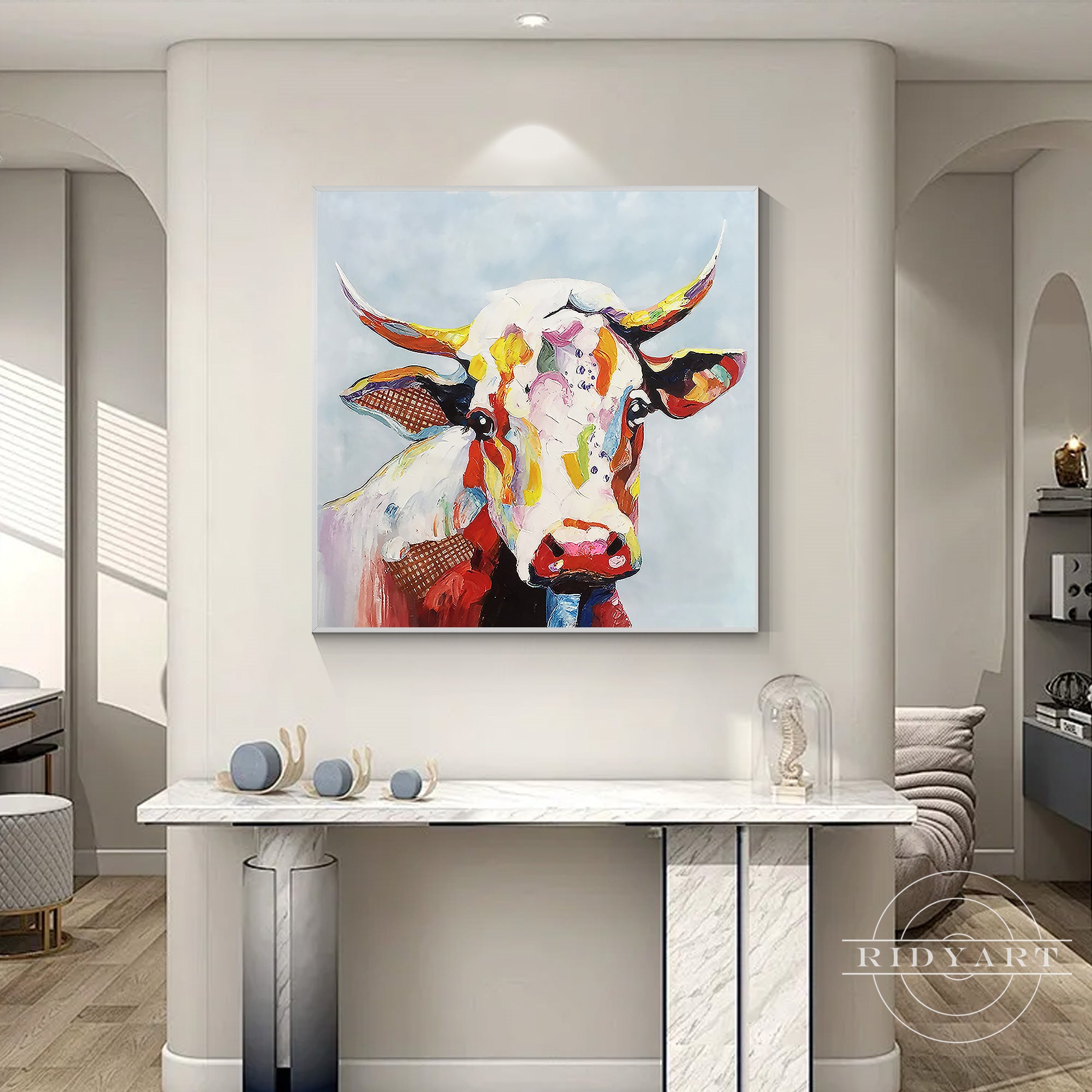 Abstract cow artwork with vivid reds, yellows, blues, and pinks creating a unique statement piece for home decor.