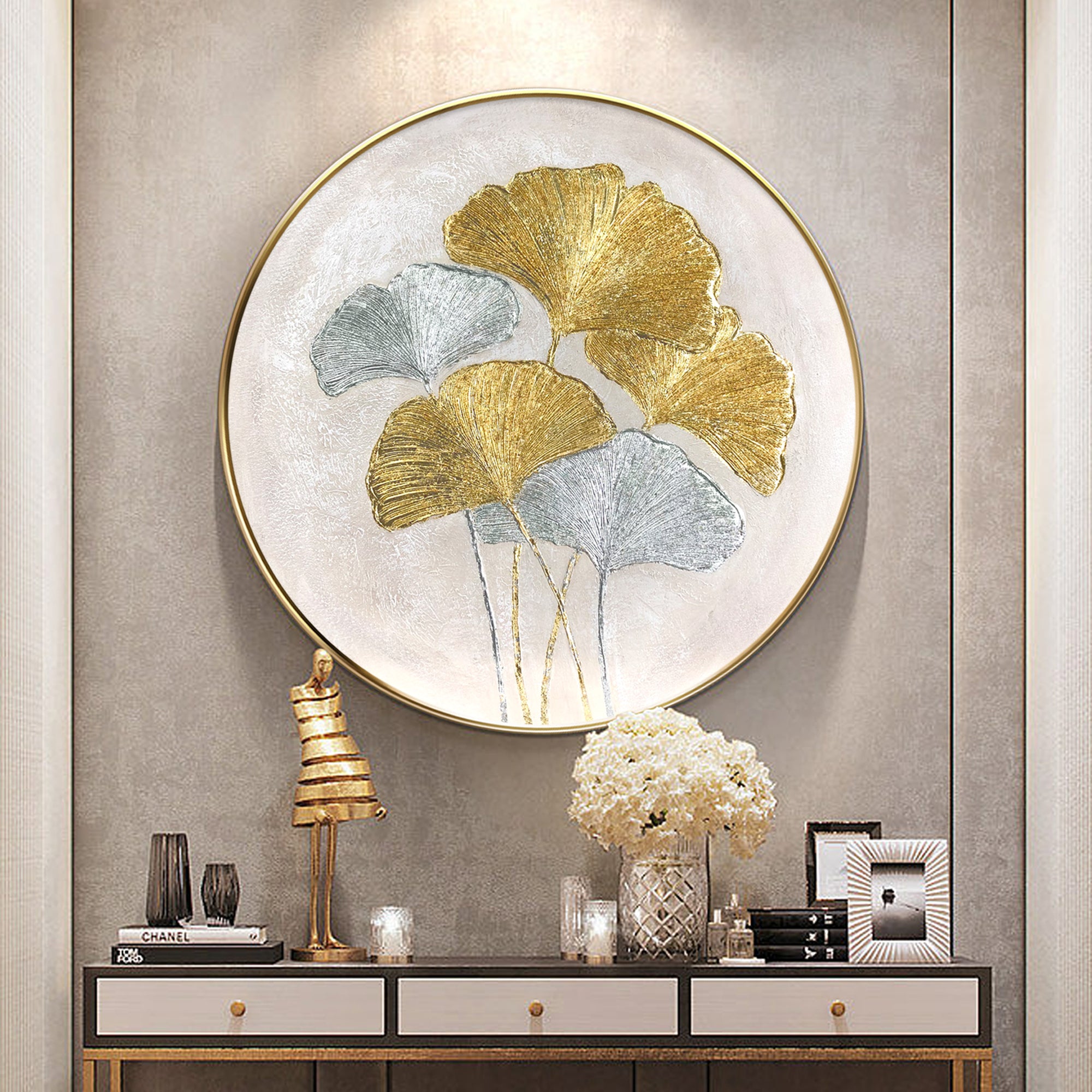 Ginkgo leaves painting featuring gold and silver foil accents. Round textured minimalist wall art for elegant and luxurious interior design.

