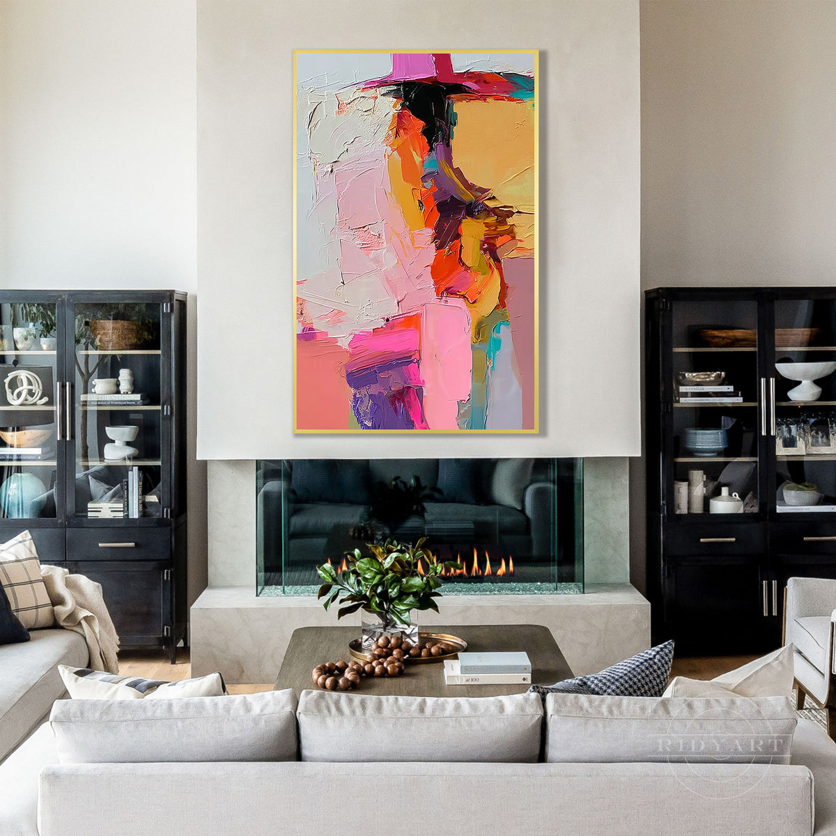 A modern colorful abstract painting in a white frame hanging on a clean wall in a bright, contemporary living room setting.