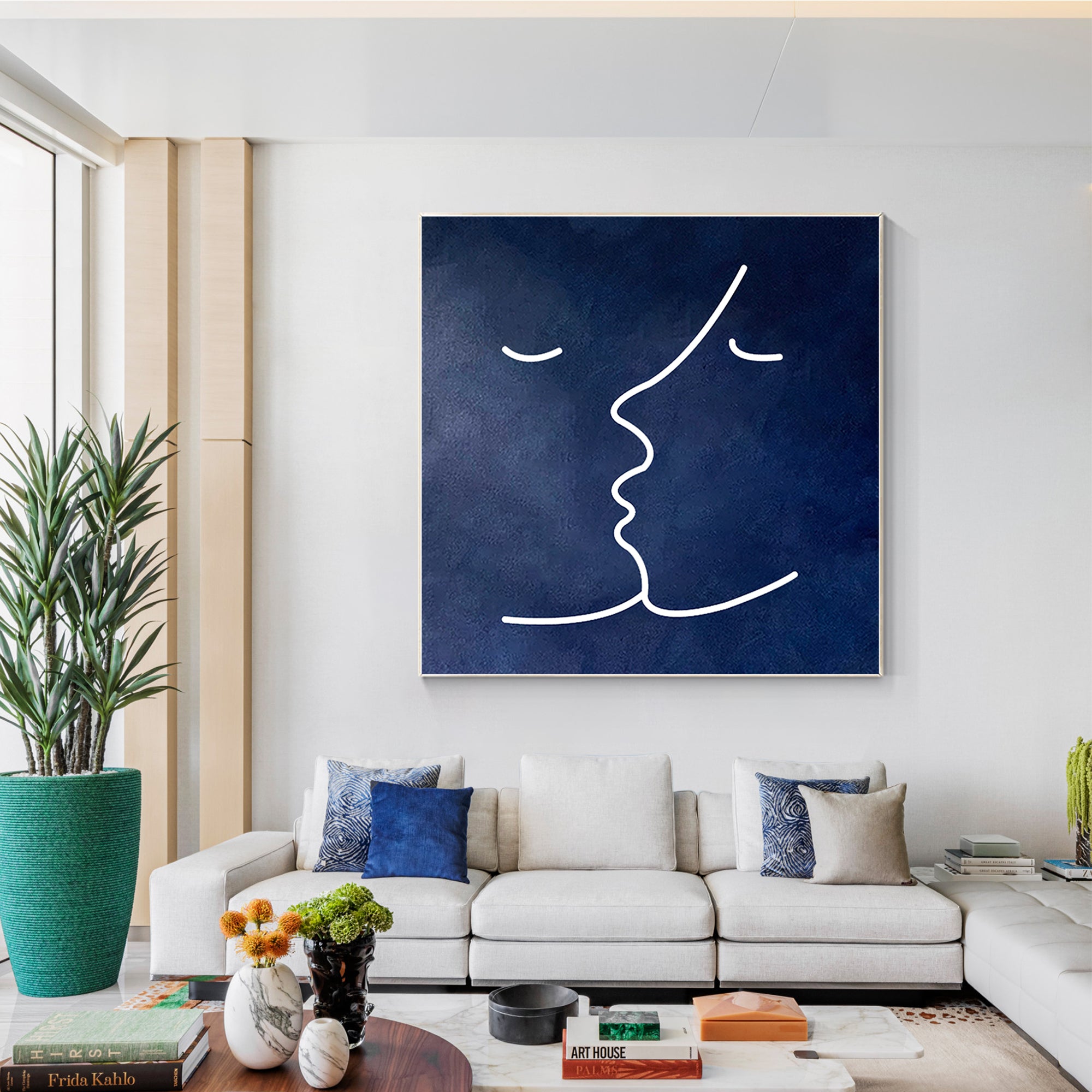 Large abstract navy blue painting with a white line art of faces, adding sophistication to home interiors