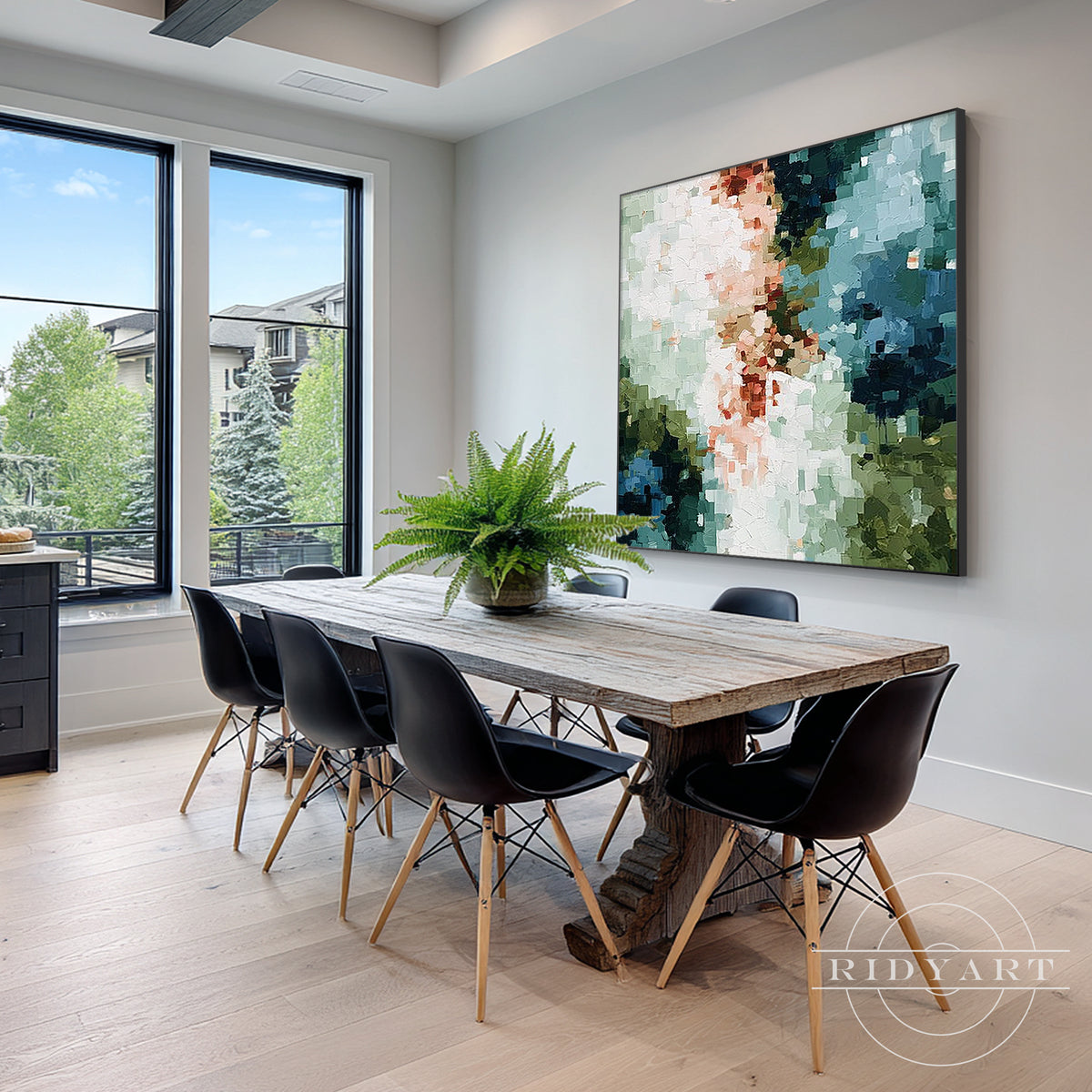 Sage green and teal abstract canvas wall art displayed above a beige sofa in a modern living room.