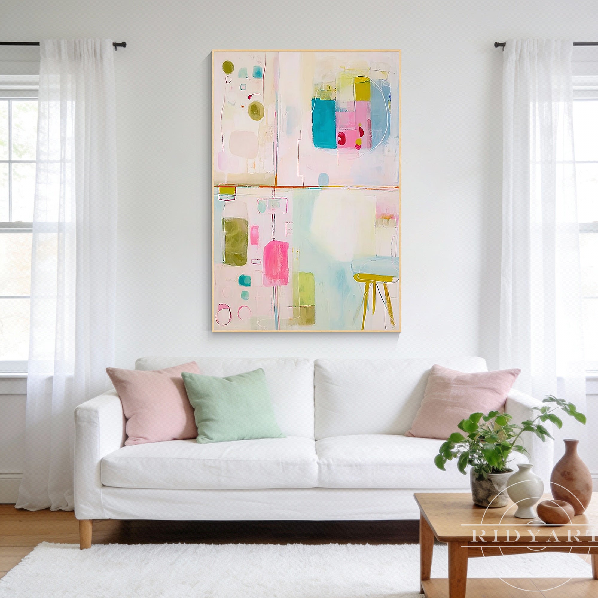Pastel abstract geometric canvas painting with pink blue and green accents in a wood frame.